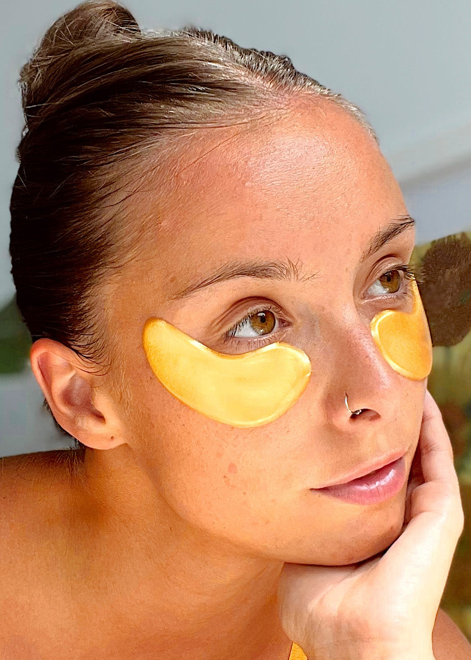 Woman applying vegan collagen eye masks to her eyes