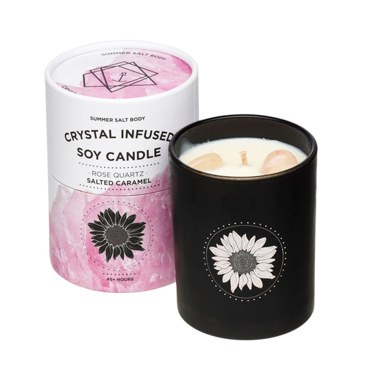Crystal infused soy candle with black lid and pink packaging on a white background. Rose Quartz Salted Caramel